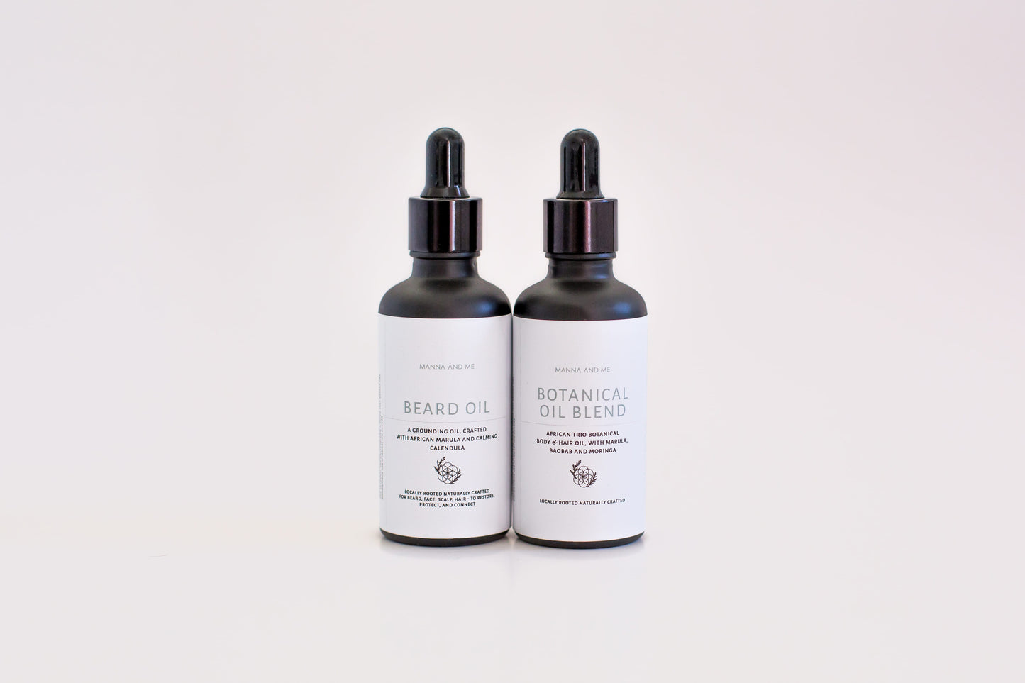 Manna and Me African Trio Body Oil glass bottle, a premium fast-absorbing body oil infused with indigenous South African botanical extracts. Manna and Me natural Beard Oil bottle with dropper, a soothing conditioning treatment crafted to prevent under-beard dryness and skin irritation.
