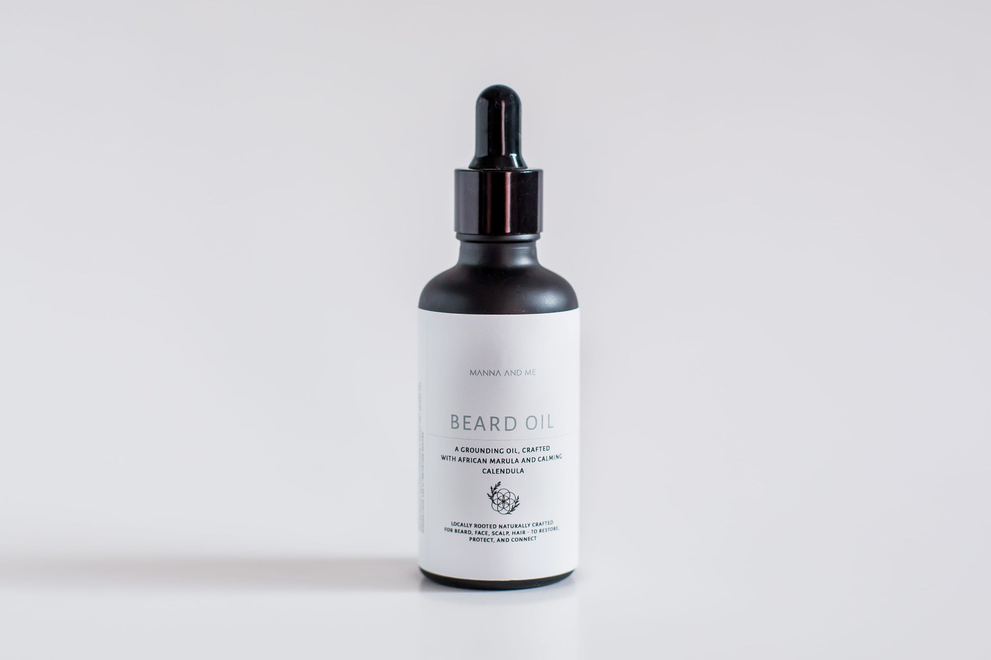 Manna and Me natural Beard Oil bottle with dropper, a soothing conditioning treatment crafted to prevent under-beard dryness and skin irritation.