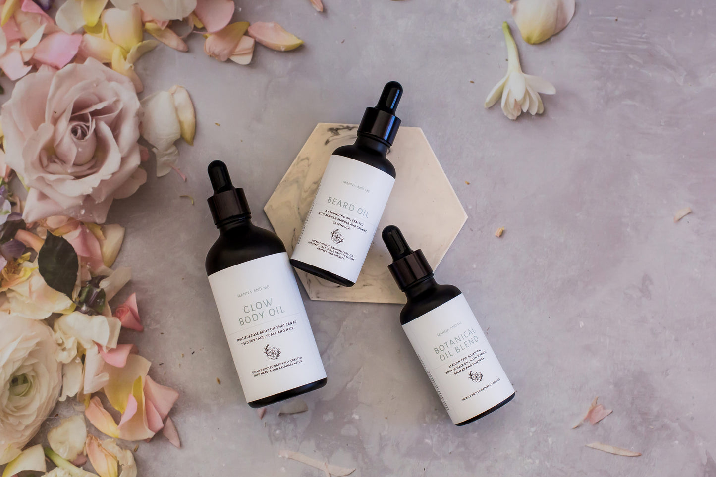 Manna and Me African Trio Body Oil bottle, deeply nourishing botanical body treatment for glowing skin.
