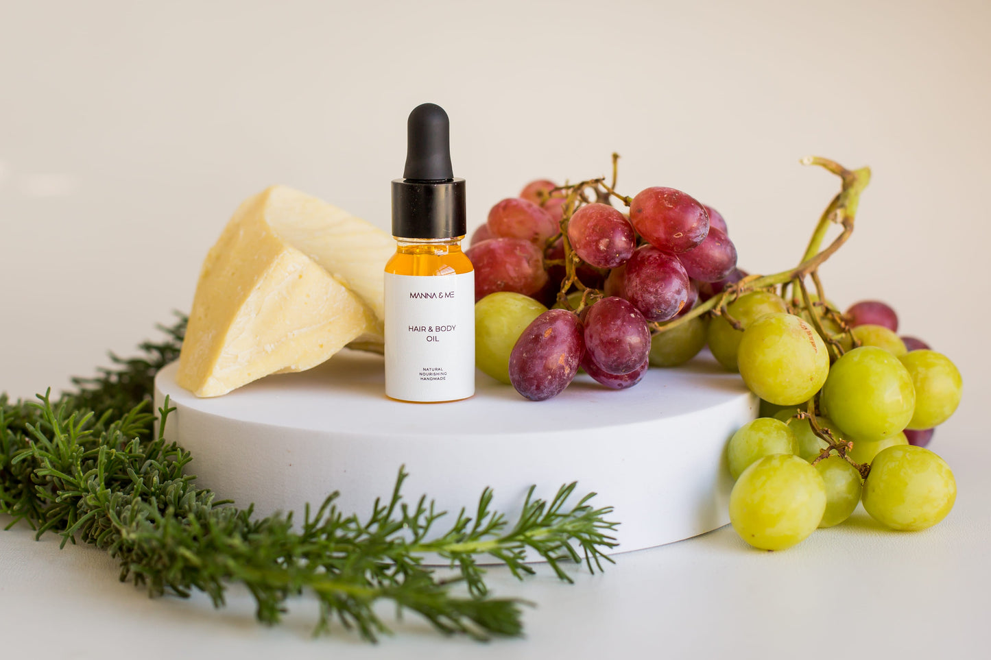 Manna and Me multi-use Hair and Body Oil glass bottle with natural botanical plant oils.